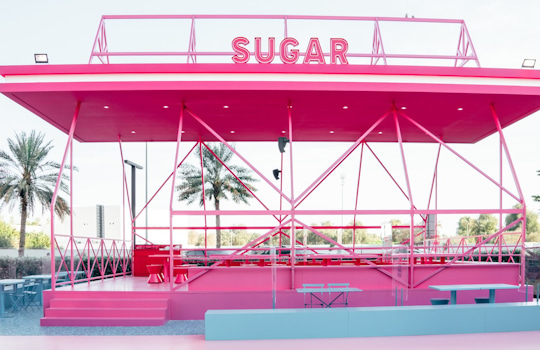 Studio Königshausen’s design for SALT CAMP in Dubai redefines camping for foodies, blending the charm of the great outdoors with a touch of glamour. We’ve created two dining areas, one for SALT and one for Sugar, offering savory meals and sumptuous desserts. The space is filled with interactive features, including a camping store, campfire confession table, and a stargazing area, all reflecting the brand’s personality. Königshausen: your partner in design, concept development, and scenography.